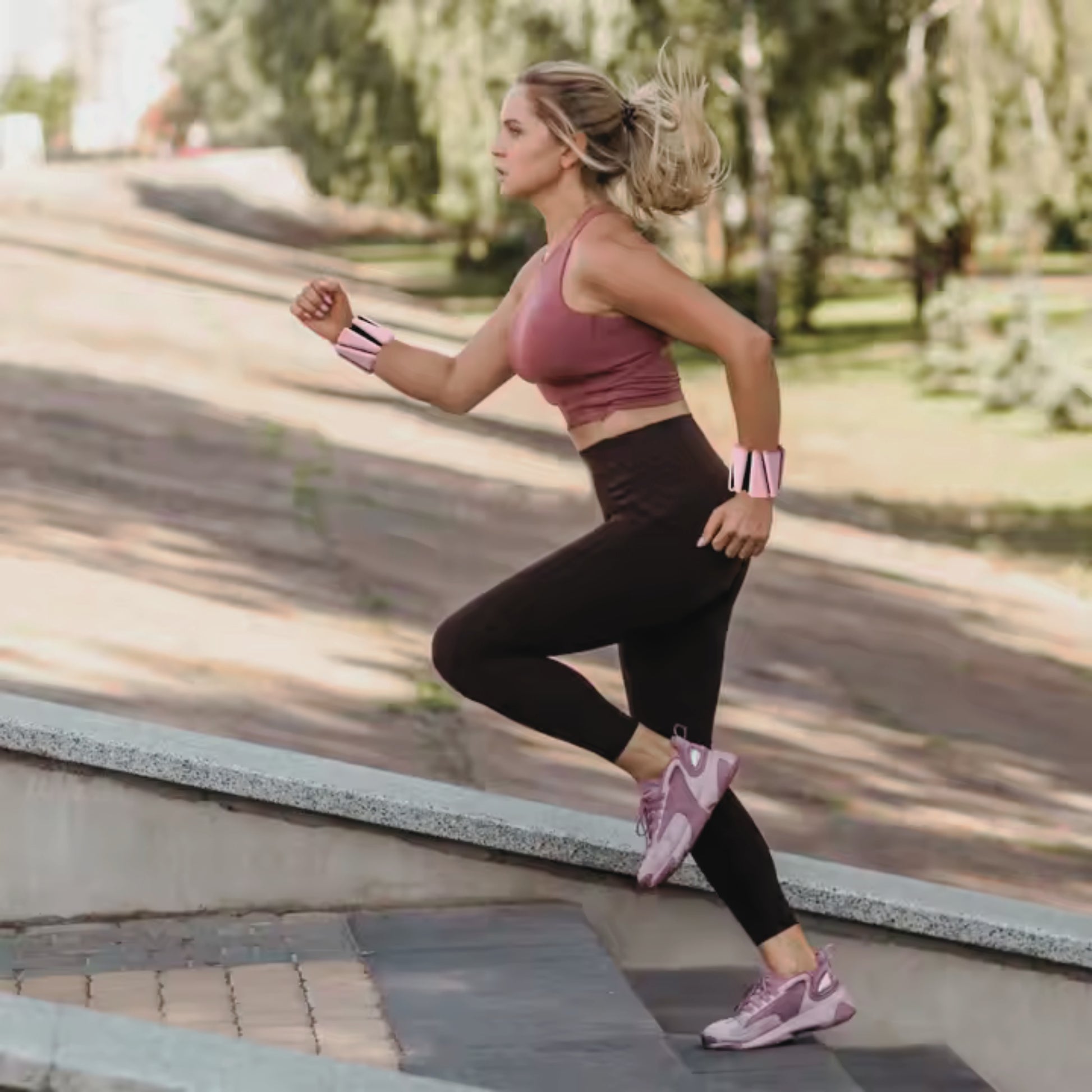 Woman running with pilates weights